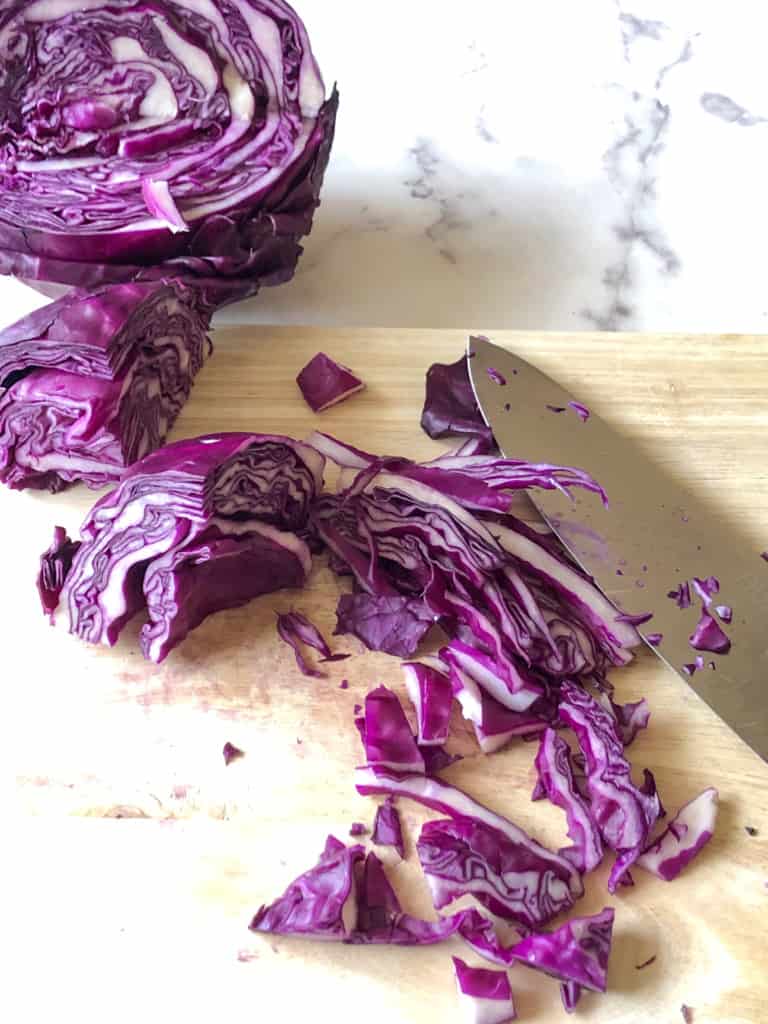thinly slicing the purple cabbage