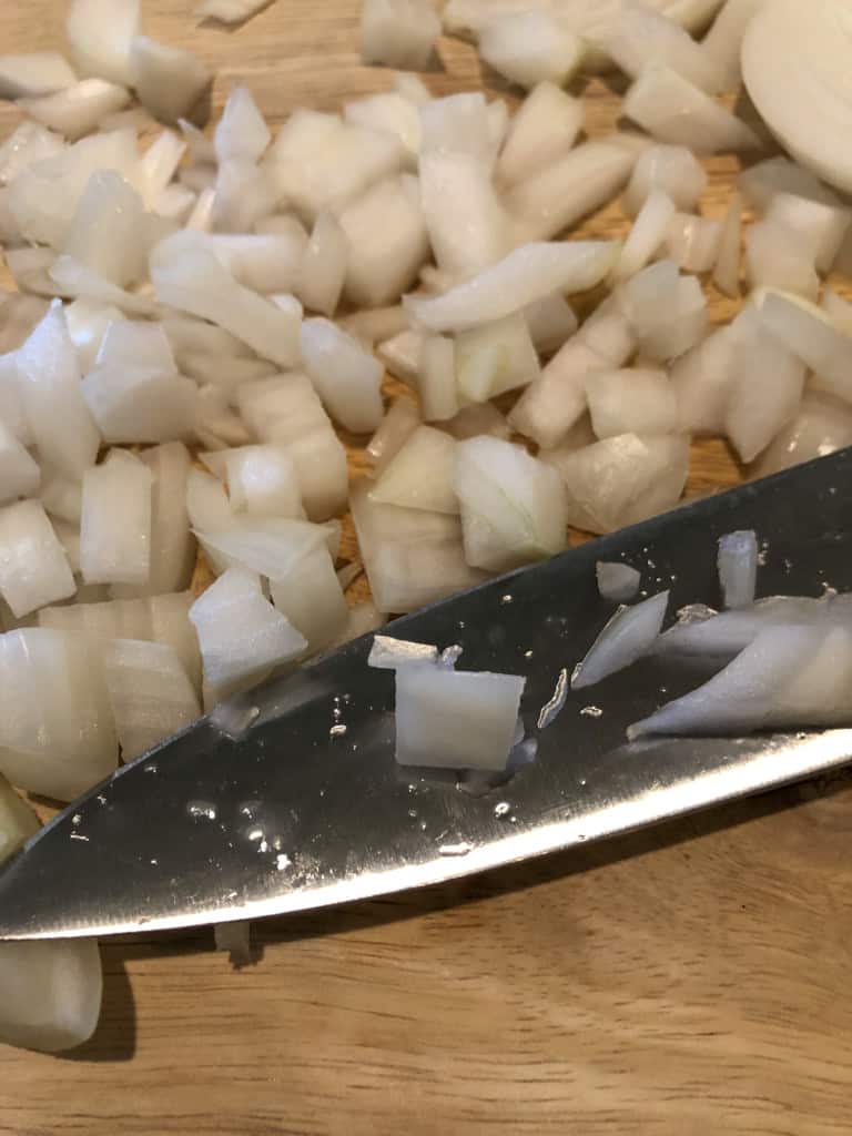 showing the size of the chopped onions relative to the large knife
