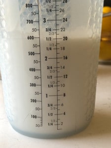measuring container showing coconut milk
