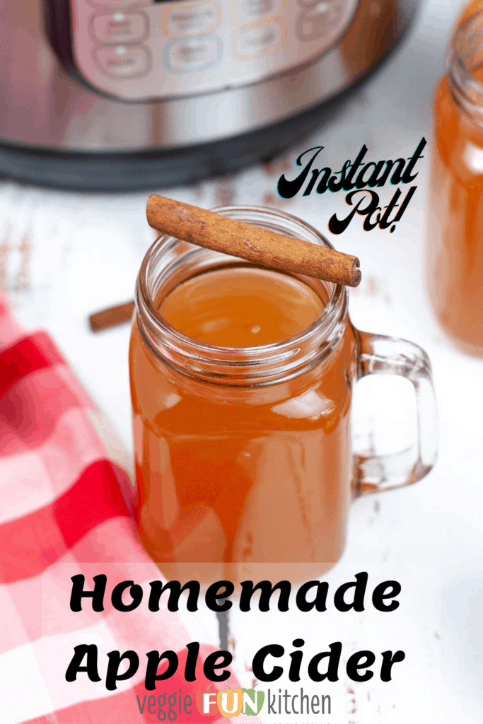 apple cider in glass mug with cinnamon stick on top and instant pot in the background with pinterest text overlay