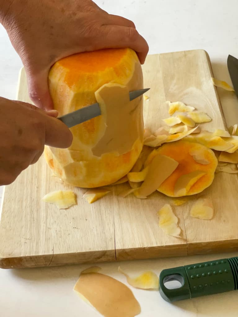 peeling the butternut squash with a paring knife