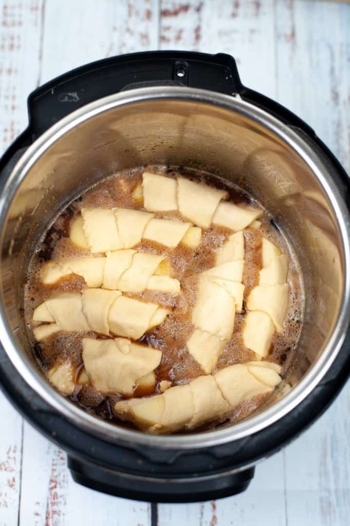 apple dumplings in the instant pot with melted butter, sugar, and cinnamon
