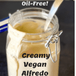 jar of vegan alfredo with ladle in jar with pinterest text overlay