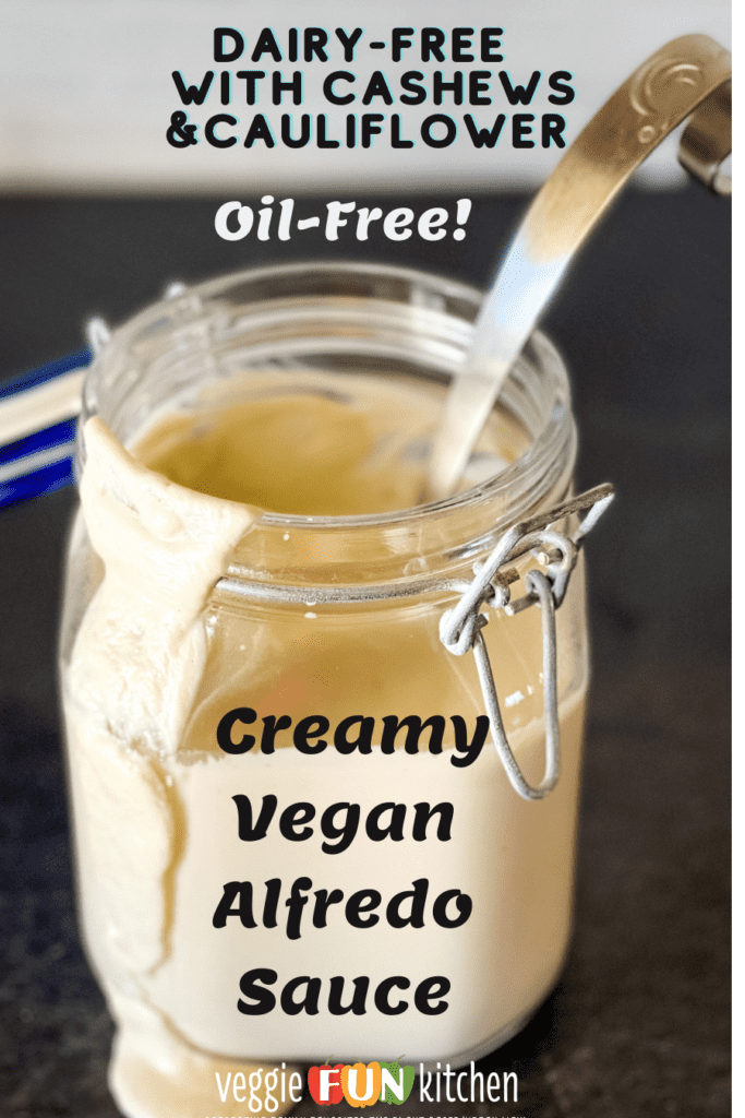 jar of vegan alfredo with ladle in jar with pinterest text overlay