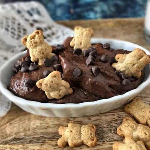 black bean brownie batter hummus in a white dish with little bear cookies taking swim