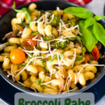 broccoli rabe pasta in black bowl with red checked napkin and pinterest text overlay