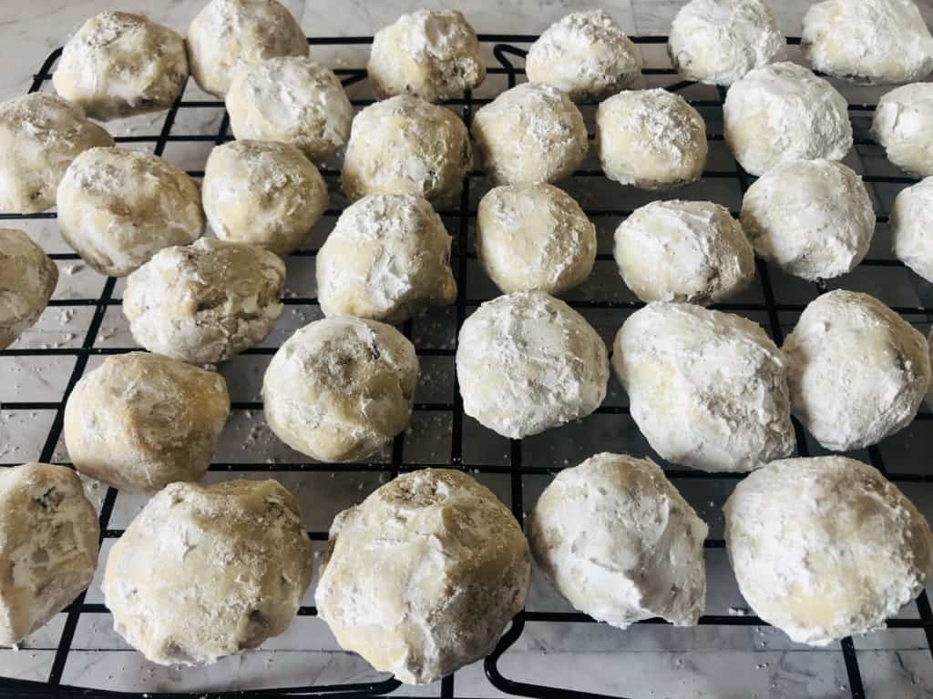 baked snowball cookies cooling on a rack