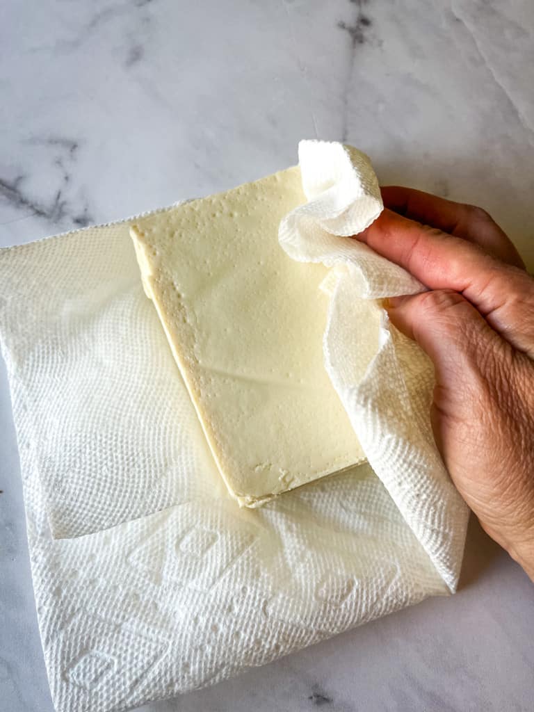 patting the silken tofu dry
