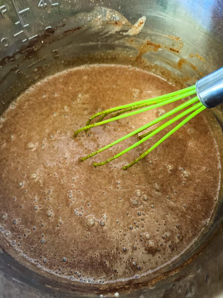 whisking the ingredients for hot chocolate together in the instant pot liner