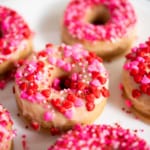 valentine decorated glazed donuts with hearts and pink napkin