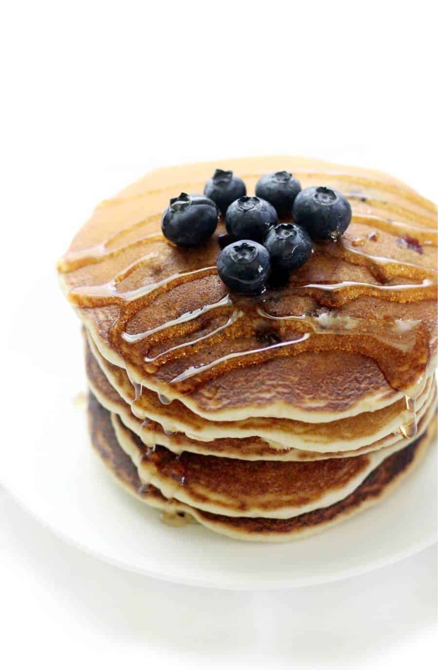 stack of blueberry pancakes with blueberries on top