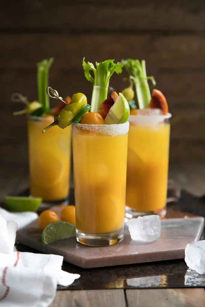 gold beet bloody marys in three glasses