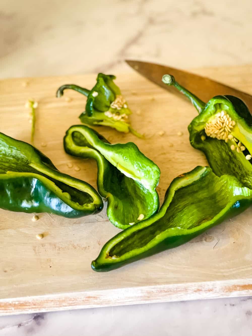 two poblano peppers cut in half
