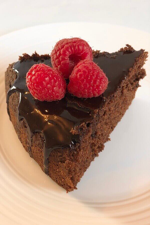 slice of chocolate buckwheat cake with raspberries