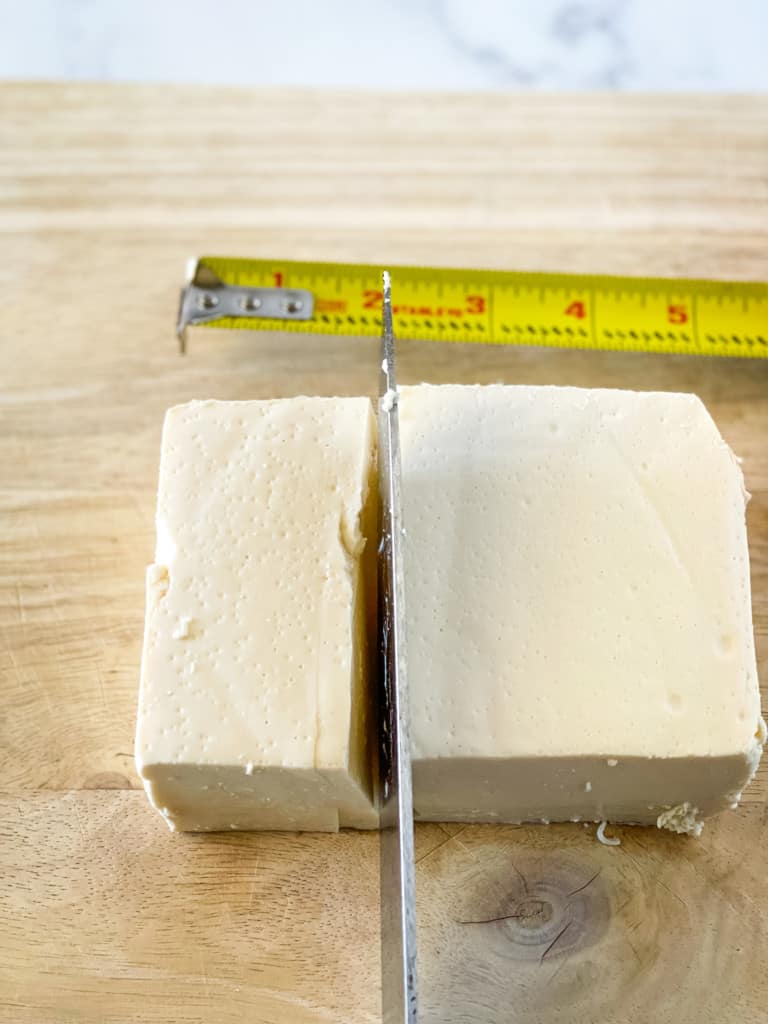 cutting off two inches from a block of tofu