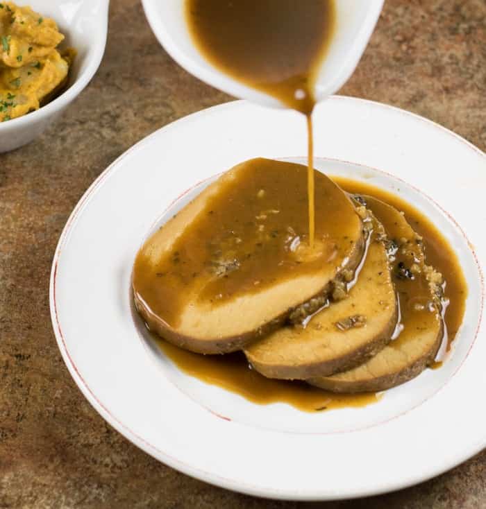 slow cooker tofurky with maple herb gravy poured on top