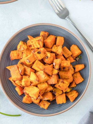 air fryer sweet potatoes in bowl with tofu scramble in background