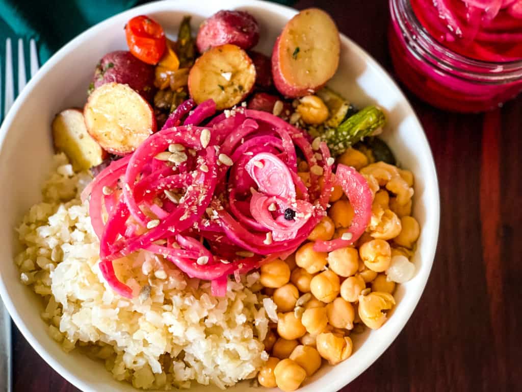 buddha bowl with rice, vegetable potato bake, garbanzos, and pink onions