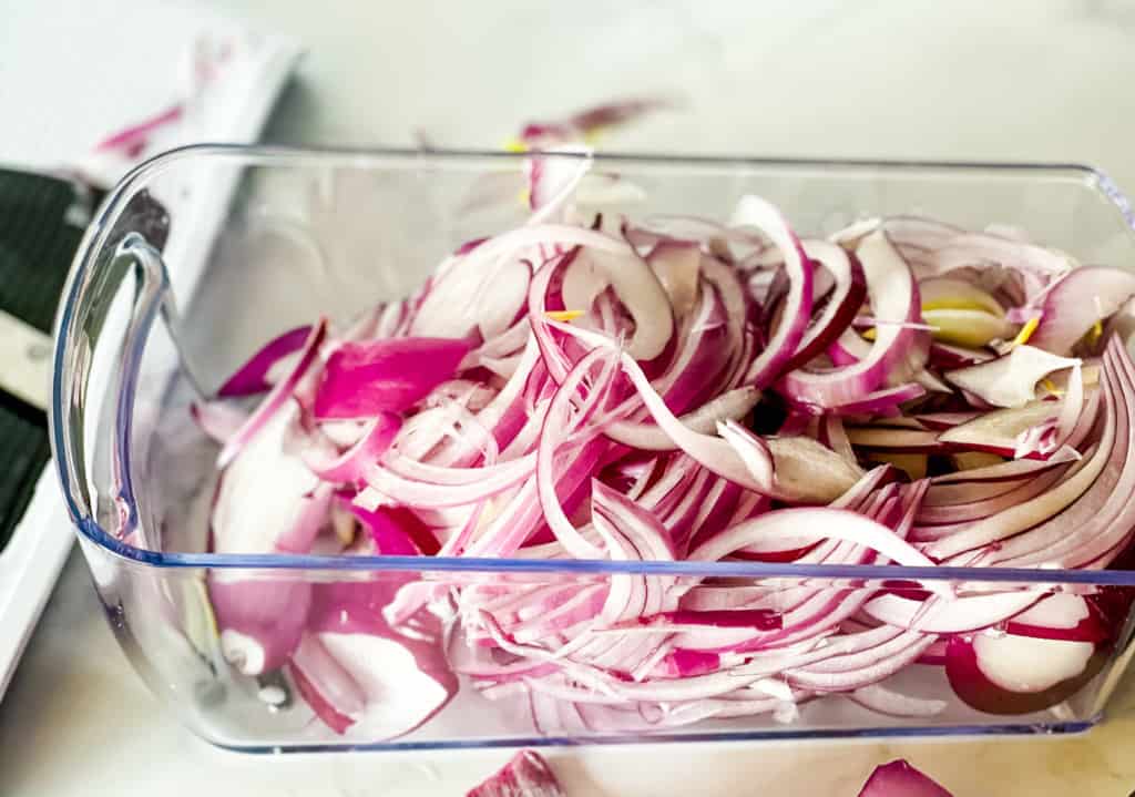 mandolin container filled with sliced red onions