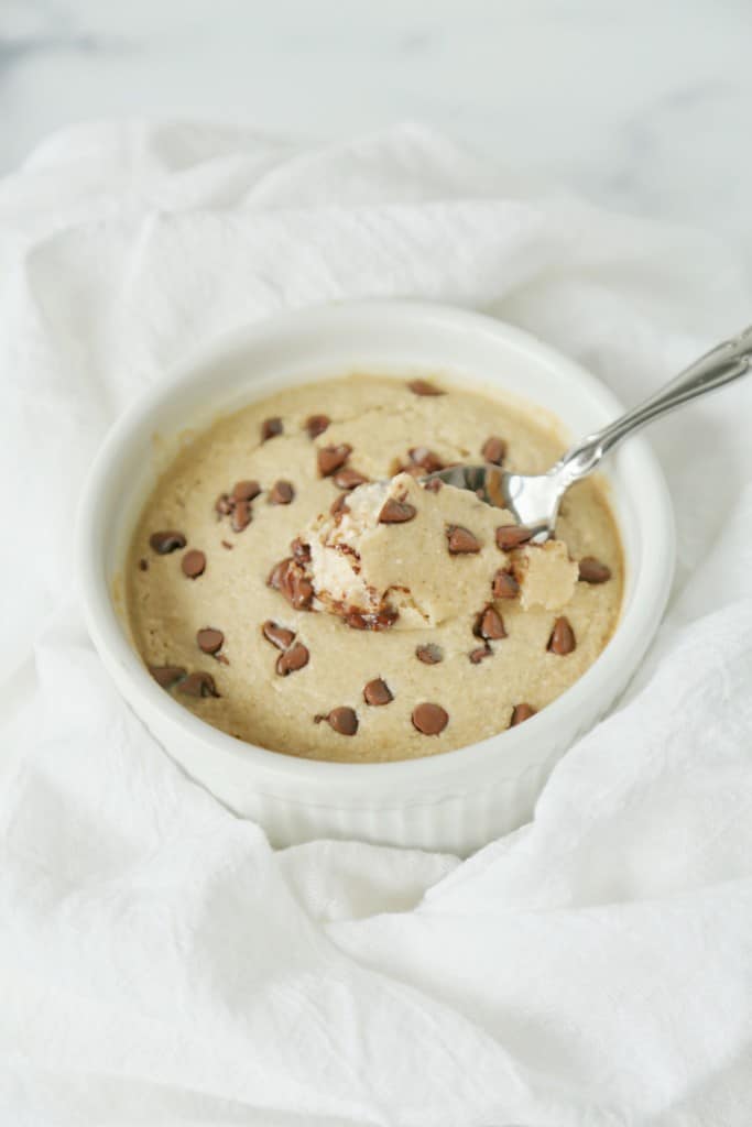 ramekin of chocolate chip baked oats with spoon inside