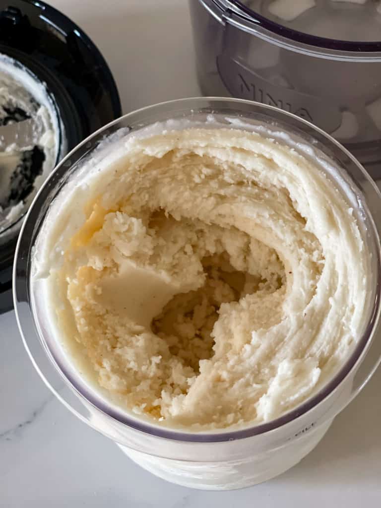 showing frozen pina colada ice cream in ninja creami container