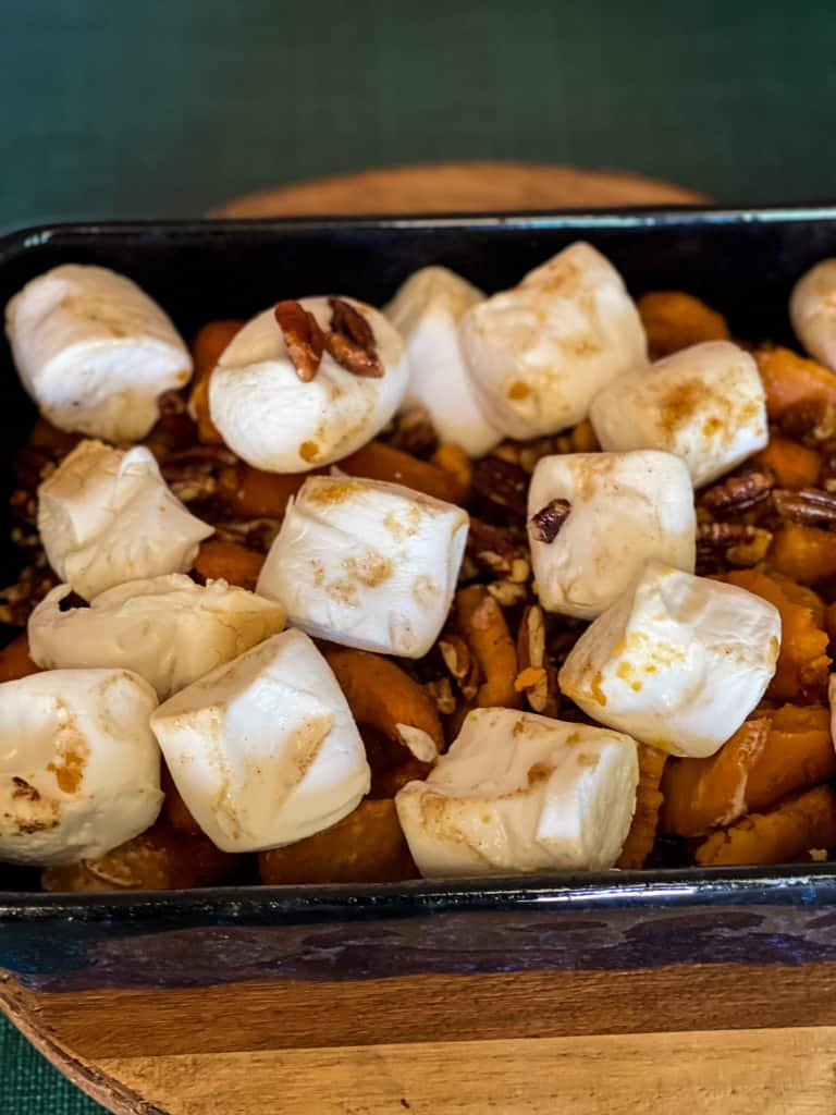 casserole dish with cooked canned yams showing big marshmallows after turning