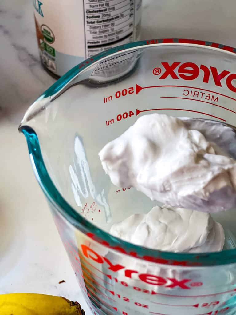 skimming the coconut cream from the can of coconut milk