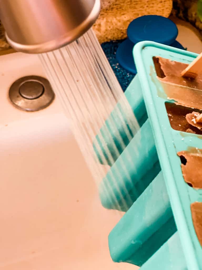 running the frozen coffee popsicle molds under warm water
