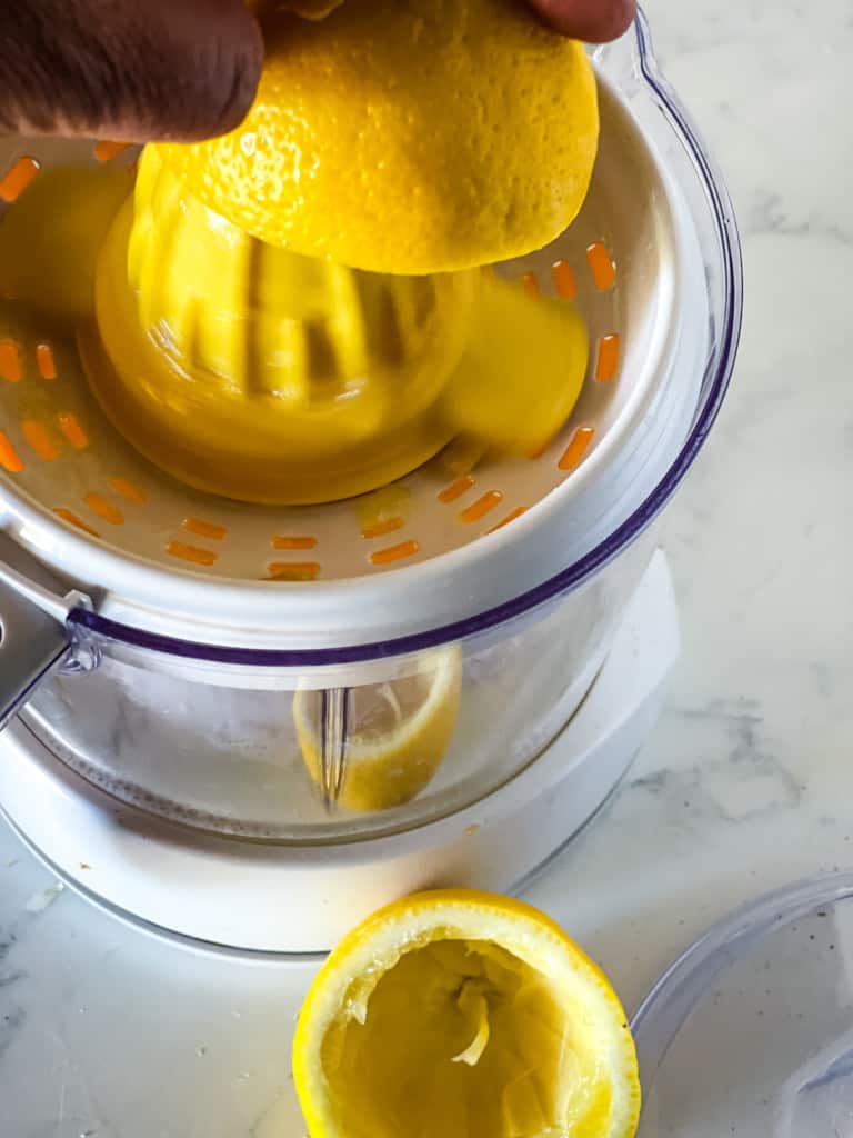 juicing the lemon in citrus juicer