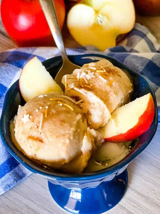 apple pie ice cream in blue dish with sprinkles on top and apple slices on the side