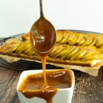 caramel drizzled in foreground with apple tart in background