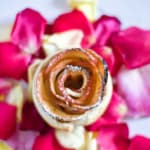 apple rose in center surrounded by rose petals