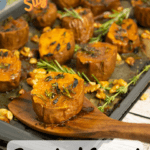 sweet potato rounds on baking sheet with rosemary and wooden spoon with pinterest text overlay