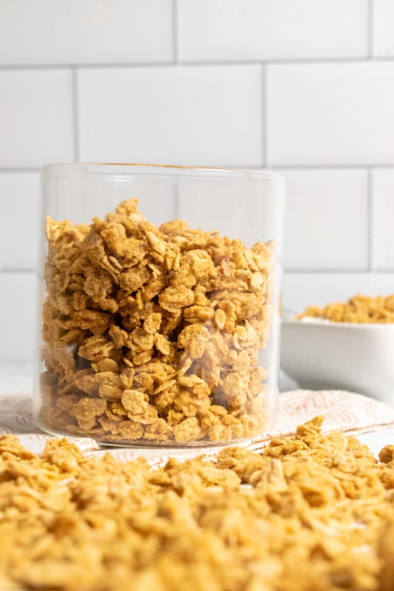 pumpkin granola on counter with glass jar of granola in background