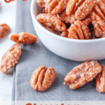 candied pecans in white bowl with pinterest text overlay