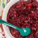bowl of cranberry apple sauce with green spoon