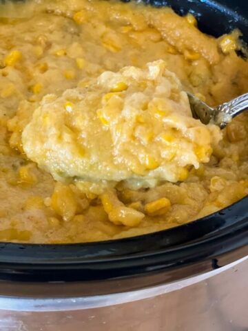 spooning cooked corn casserole to show pudding like texture