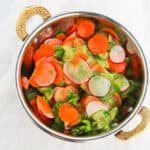 cucumber carrot salad in a brass bowl