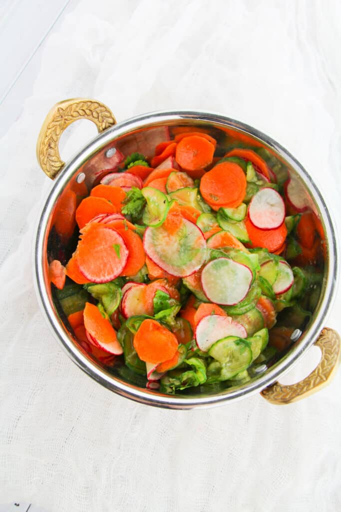 cucumber carrot salad in a brass bowl
