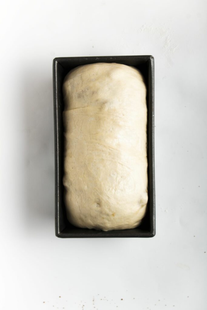 prepared loaf of cinnamon swirl bread in loaf pan