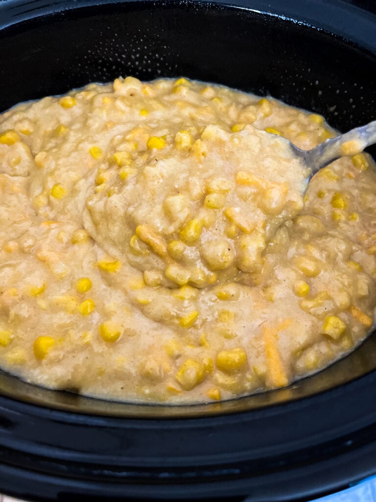 stirring uncooked corn casserole in crockpot