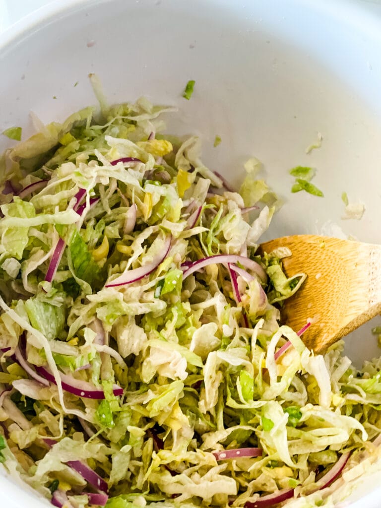 MIxing up the lettuce slaw for grinder sandwiches.