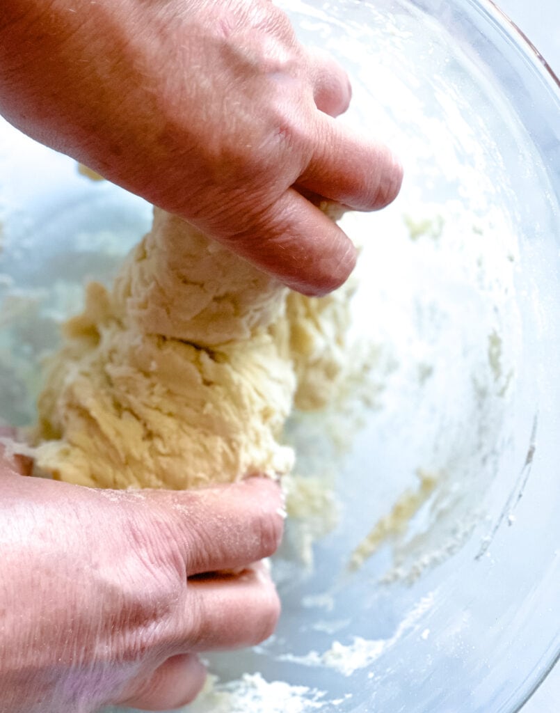 hand mixing the dough for vegan burger buns.