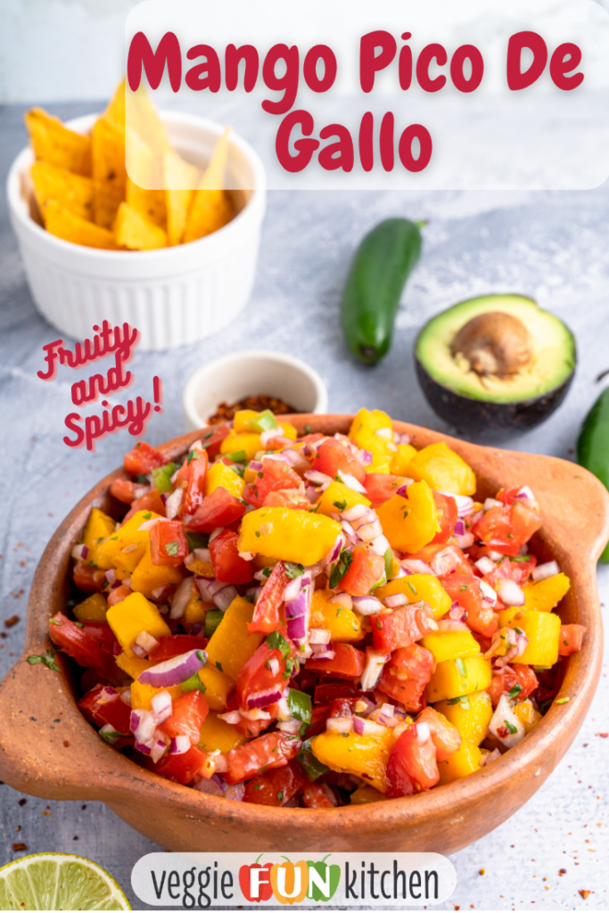 Mango Pico de Gallo in a bowl in front with chips, jalapeno pepper, and half an avocado in the background with pinterest text overlay