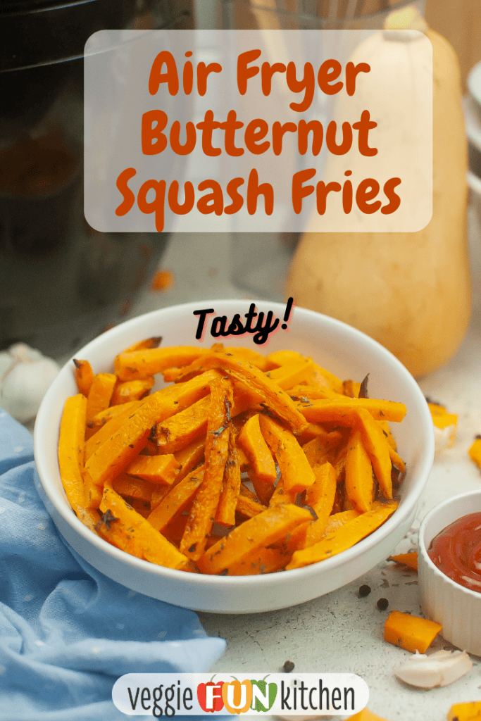 A white bowl of butternut squash fries with a butternut squash in the background. With pinterest text overlay.