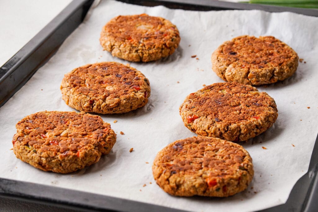 Six cooked white bean burgers.