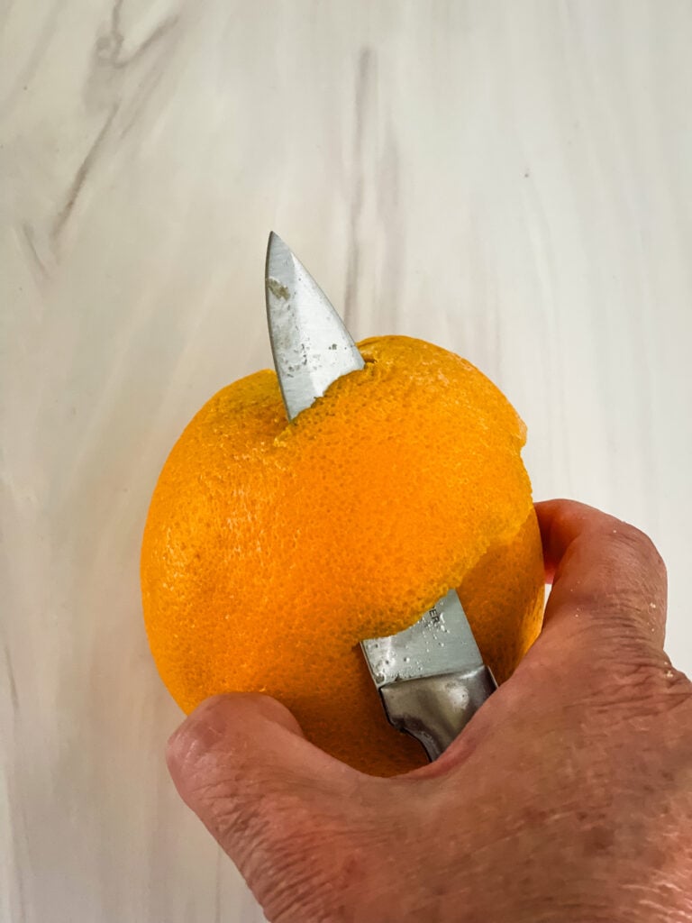 Removing the orange peel with a paring knife for pear butter