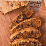 slices of pumpkin bread with chocolate chips on a bread board with pinterest text overlay.