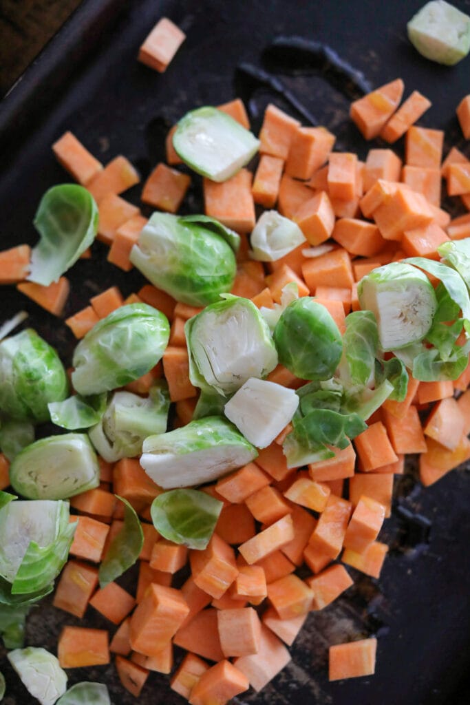 Cubed sweet potato with cut Brussles sprouts.