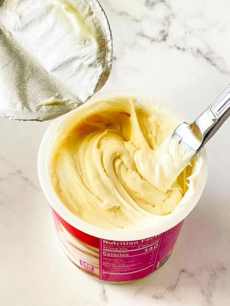 Stirring the cream cheese frosting with a knife while it's in the can.